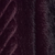 Close-up of dark purple fabric with a subtle diagonal ribbed texture.