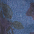 Dark blue textured surface featuring a faint botanical leaf pattern.