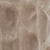 A close-up view of light brown, fine-grained sand featuring soft, uneven ridges and small depressions creating a textured surface.