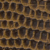Close-up of a textured surface showing a repeating pattern of brown and black hexagonal shapes, resembling snake or reptile scales.