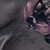 A close-up of a human hand resting on a textured surface.
