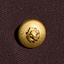 A gold button with a raised floral design is sewn onto dark brown or burgundy fabric.