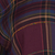 A dark purple, blue, and gold plaid fabric pattern.
