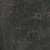 Dark, textured surface featuring a small, faint blue circular icon.