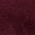 A close-up of a textured, dark reddish-brown surface, possibly leather or painted material, with subtle variations in color and small, irregular patterns.