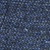 Close-up view of blue denim fabric, showing a detailed texture with interwoven white threads and a slightly rough surface.