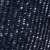 Close-up of dark blue fabric with vertical rows of small, reflective, silver or white sequins, creating a sparkling, textured pattern.