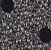 Black fabric patterned with small white polka dots.