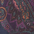 Close-up of a dark fabric featuring a multi-colored paisley pattern.