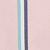 A close-up of a pink surface with three vertical stripes: one teal, one white, and one dark blue, positioned next to each other.