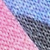Close-up of three woven textured fabrics in diagonal sections: pink on the left, blue on the right, and gray in the center. The materials appear to be made of synthetic fibers.