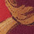 A close-up of a brown, textured mushroom against a vibrant red background.