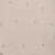 A beige or off-white textured surface with small, scattered golden dots evenly spaced across it. The overall appearance is soft and minimalistic.