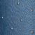 A textured blue surface with a wavy, embossed pattern and several small, shiny metallic spheres scattered across it.