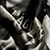 A close-up of a hand gripping a bottle with the letters AGE visible on the product label.