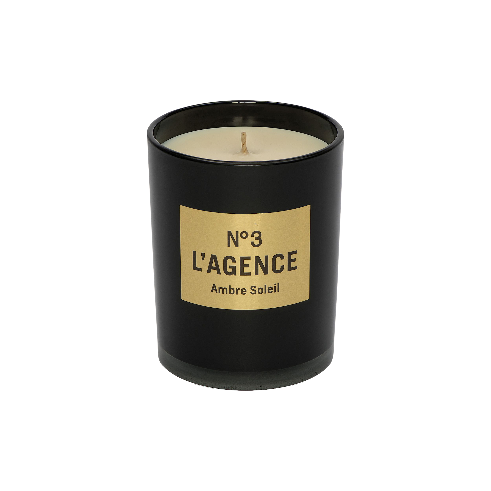 A hand-poured Ambre Soleil candle, featuring a black jar with a gold label that reads Nº 3 LAGENCE and filled with light-colored, unused soy-blend wax. This elegant candle brings sophistication to your space and provides a long-lasting burn for extended enjoyment.