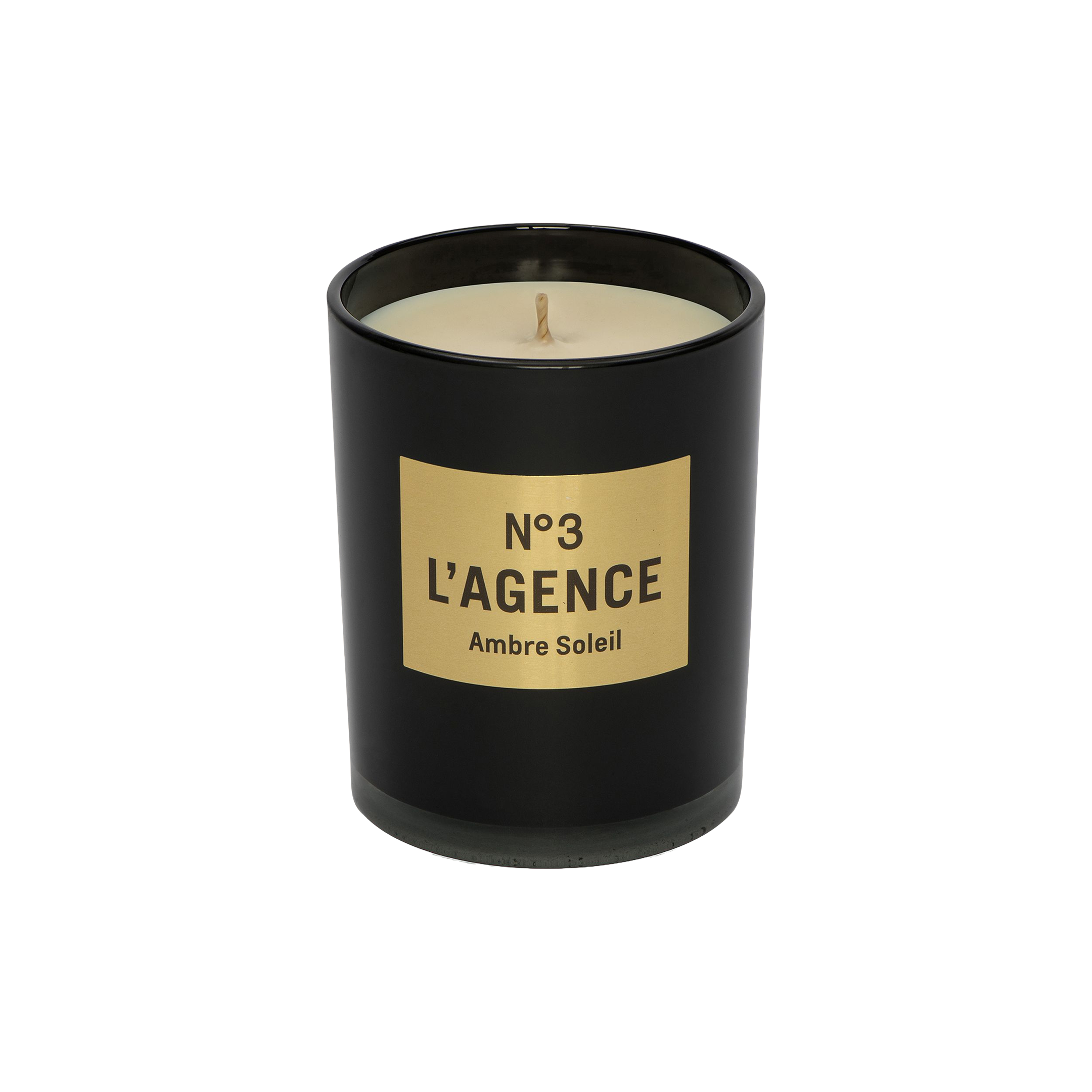 A hand-poured Ambre Soleil candle, featuring a black jar with a gold label that reads Nº 3 LAGENCE and filled with light-colored, unused soy-blend wax. This elegant candle brings sophistication to your space and provides a long-lasting burn for extended enjoyment.