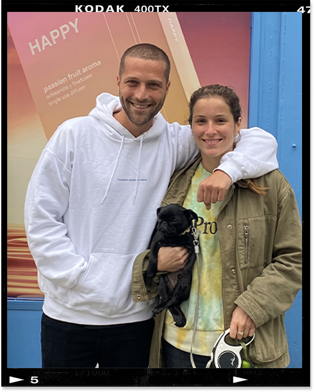 Sam Beecham, ripple⁺ co-founder, with his partner and their dog outside a ripple⁺ HAPPY pop-up
