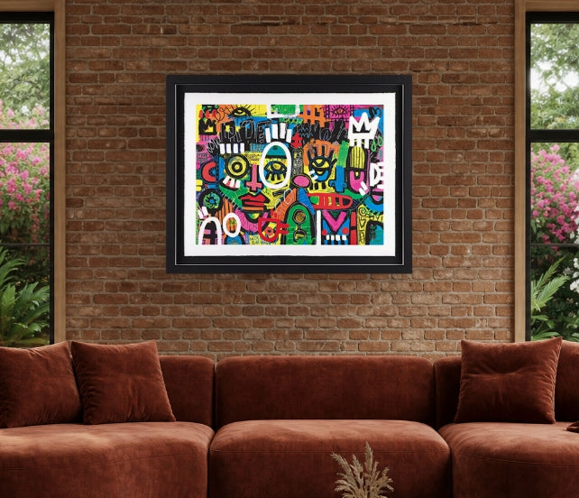 A framed colorful abstract art print with a black frame and white mat, displayed on a brown brick wall above a rust-brown velvet sectional sofa.