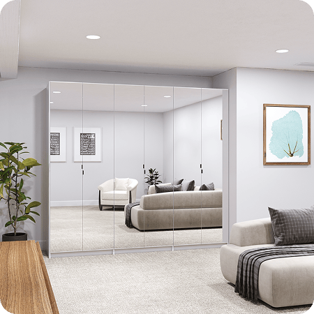 White wardrobe with 6 full-length mirrored doors and matte black minimalist pulls installed in a modern living area