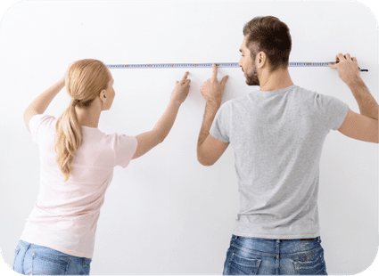 Couple measuring a wall