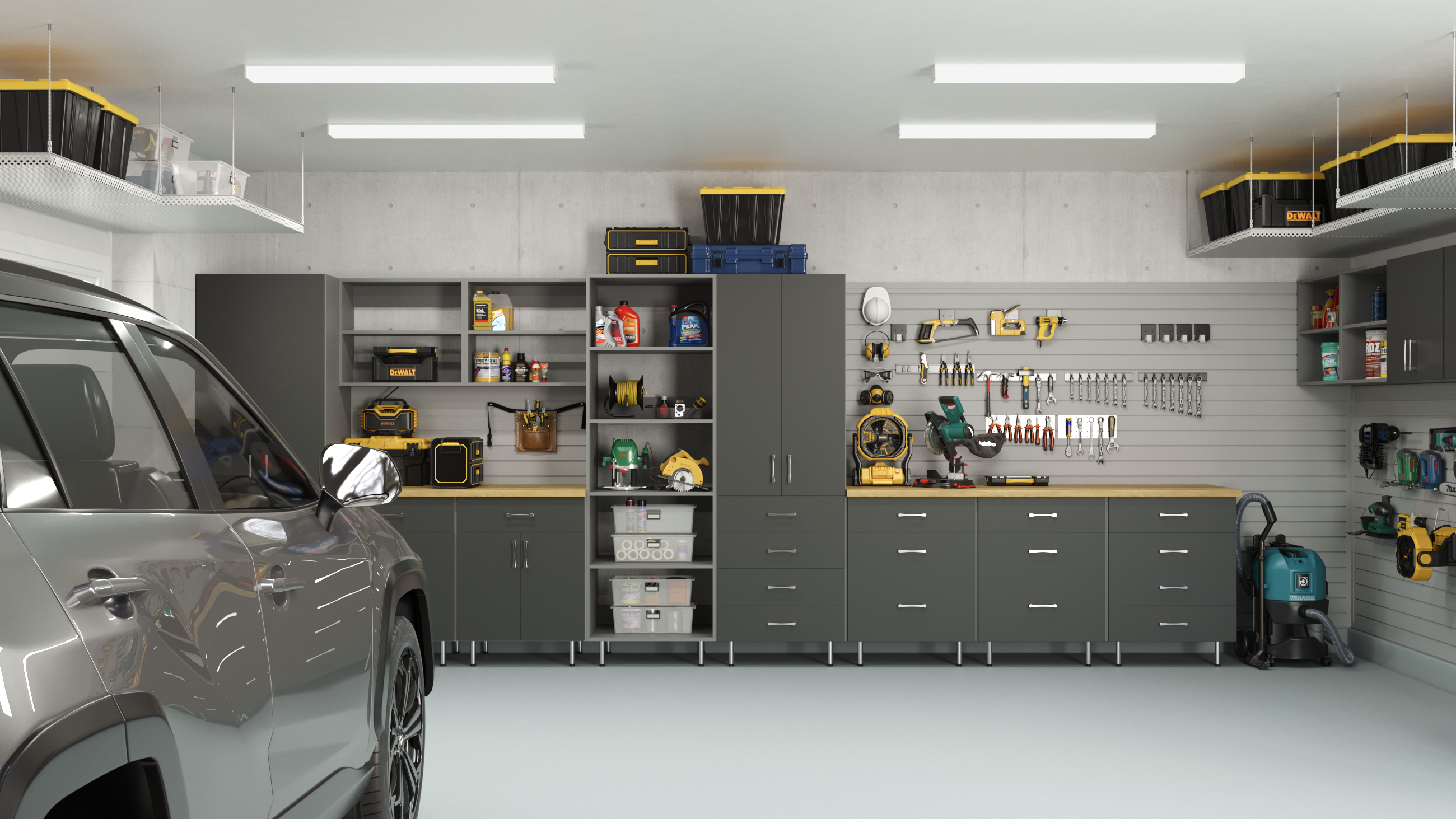 Grey garage system: features a wood countertops, slatwall tool storage, tall cabinets, drawers & overhead ceiling racks