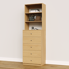 Natural oak drawer cabinet with slab fronts for linens, towels, and folded clothing.