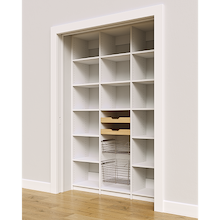 White 57 inch reach in pantry with two wood pull-out drawers and two pull-out wire baskets.