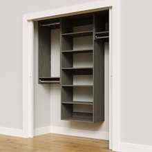 Grey 64.5-inch woodgrain Vista Total Closet Kit, angled view, empty, with tall hanging in a reach-in closet