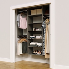 Grey 64.5-inch woodgrain Vista Total Closet Kit in a reach-in closet with dresses, shoes, and handbags
