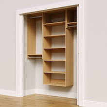 Natural oak 64.5-inch woodgrain Vista Total Closet Kit, angled view, empty, with tall hanging in a reach-in closet