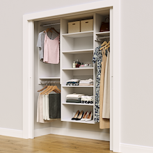 White 64.5-inch Vista Total Closet Kit in a reach-in closet with dresses, shoes, and handbags