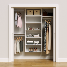 White 64.5-inch Vista Total Closet Kit, front view in a reach-in closet, holding dresses