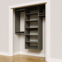 Grey 67.5-inch woodgrain Vista Total Closet Kit, angled view, empty, with tall hanging in a reach-in closet