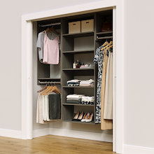 Grey 67.5-inch woodgrain Vista Total Closet Kit in a reach-in closet with dresses, shoes, and handbags