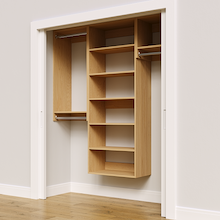 Natural oak 67.5-inch woodgrain Vista Total Closet Kit, angled view, empty, with tall hanging in a reach-in closet