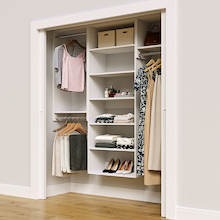 White 67.5-inch Vista Total Closet Kit in a reach-in closet with dresses, shoes, and handbags