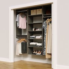 Grey 70.5-inch woodgrain Vista Total Closet Kit in a reach-in closet with dresses, shoes, and handbags