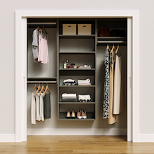 Grey 70.5-inch woodgrain Vista Total Closet Kit, front view in a reach-in closet, holding dresses