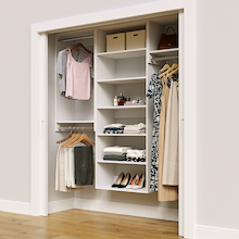 White 70.5-inch Vista Total Closet Kit in a reach-in closet with dresses, shoes, and handbags