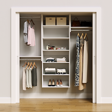 White 70.5-inch Vista Total Closet Kit, front view in a reach-in closet, holding dresses