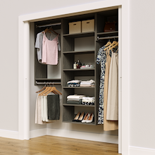 Grey 73.5-inch woodgrain Vista Total Closet Kit in a reach-in closet with dresses, shoes, and handbags