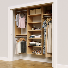 Natural oak 73.5-inch woodgrain Vista Total Closet Kit in a reach-in closet with dresses, shoes, and handbags
