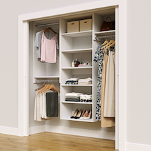 White 73.5-inch Vista Total Closet Kit in a reach-in closet with dresses, shoes, and handbags
