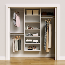 White 73.5-inch Vista Total Closet Kit, front view in a reach-in closet, holding dresses
