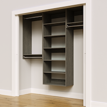Grey 76.5-inch woodgrain Vista Total Closet Kit, angled view, empty, with tall hanging in a reach-in closet