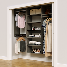 Grey 76.5-inch woodgrain Vista Total Closet Kit in a reach-in closet with dresses, shoes, and handbags