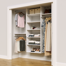 White 76.5-inch Vista Total Closet Kit in a reach-in closet with dresses, shoes, and handbags