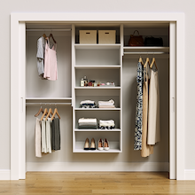 White 79.5-inch Vista Total Closet Kit, front view in a reach-in closet, holding dresses
