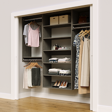 Grey 82.5-inch woodgrain Vista Total Closet Kit in a reach-in closet with dresses, shoes, and handbags